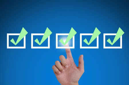 hand pointing a mark the check boxes. on a touch screen interface.の写真素材