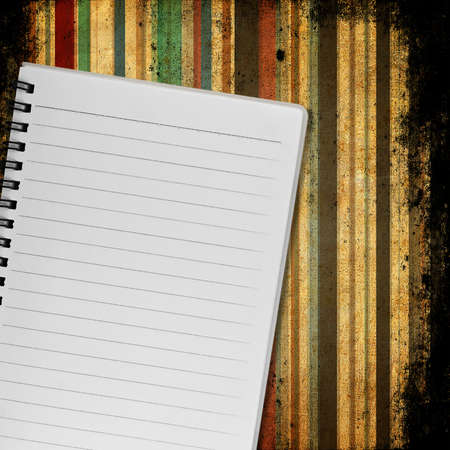 Blank notebook on old paper backgroundの写真素材