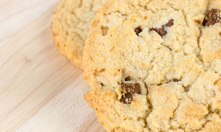 Chocolate chip cookies on wooden table.