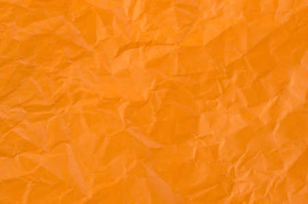 Orange crumpled paper for texture or background.の写真素材