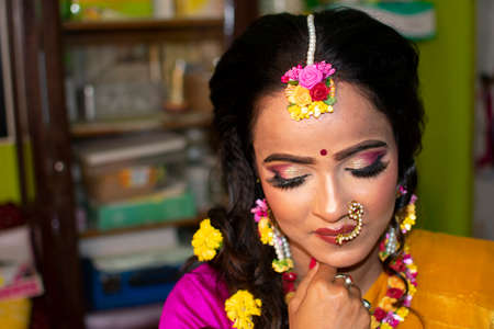 an indian woman wearing traditional dress and flower ornaments