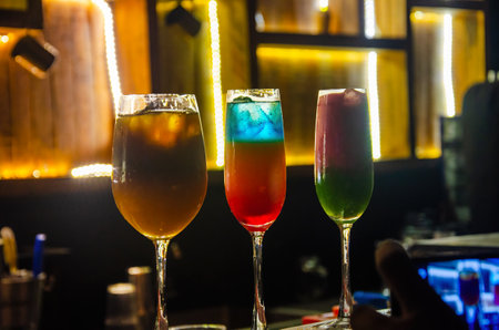 Colorful cocktails on the bar counter in a night club. Alcoholic drinks.の写真素材