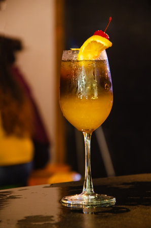 Cocktail with orange on the bar, close-up.の写真素材