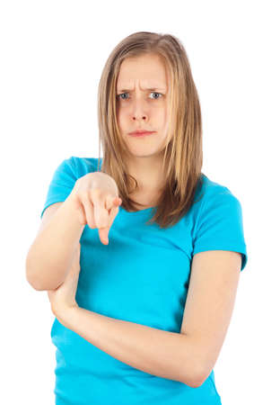 Young blond girl pointing on somebody because she is furious の写真素材