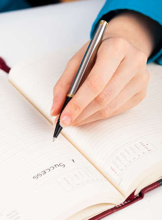Beautiful hand  listing the things neededの写真素材