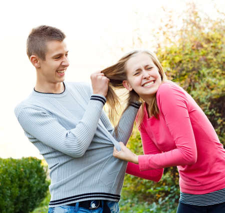 Siblings fighting, brother pulling his sister's hair.の写真素材