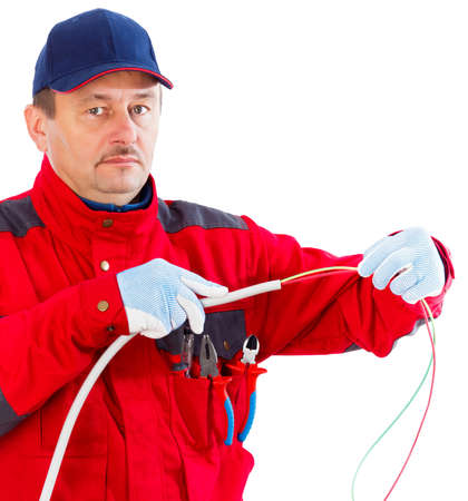 Friendly electrician plugging cable in flexible tube.の写真素材