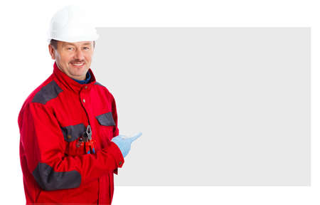 Smiling electrician pointing at a blank billboard.の写真素材