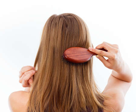 Woman combing her beautiful healthy hair.の写真素材