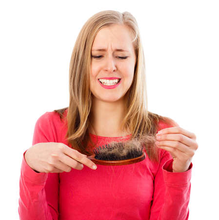 Woman being stressed of huge hair loss - seasonal alopecia.の写真素材