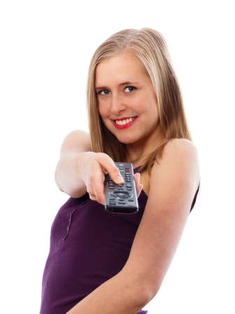 Cheerful young lady switching between tv channels.の写真素材