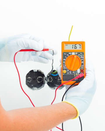 Close-up of electrician measuring voltage in current socket.の写真素材