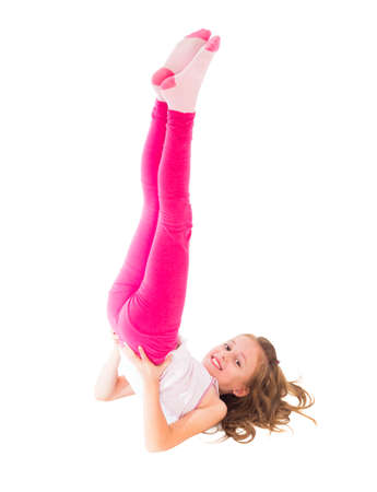 Little fit girl making perfect candle pose.の写真素材
