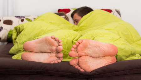 Cute couple lying in bed asleep, intimate moment.