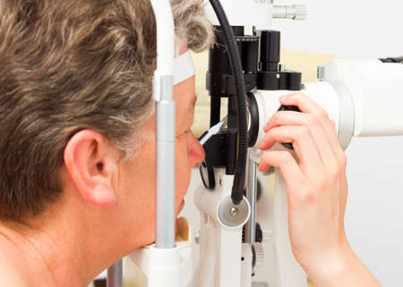 Close-up of a lady being examined with optical device.