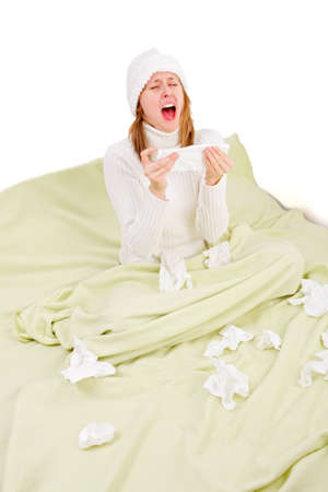 Young girl staying in bed, suffering from influenza and sneezingの写真素材