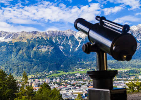 Whole city and alps mountain landscape with telescope.の写真素材