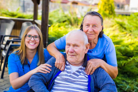 Toothy smile from physician caring of senior couple at the nursing home.