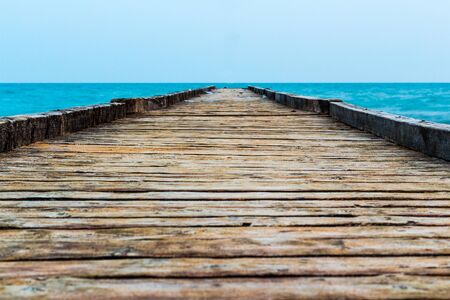 Wooden pier on the blue sea and blue sky