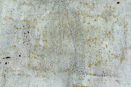Old cracked white coat of paint background with leaky rust.の写真素材