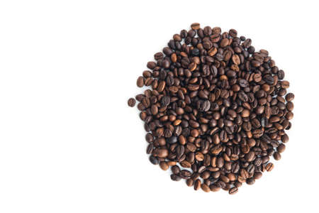 coffee beans, lie in the shape of a circle on a white background, top view.の写真素材