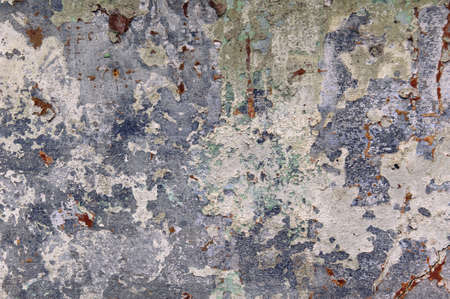 background, old concrete wall with peeling paintの写真素材