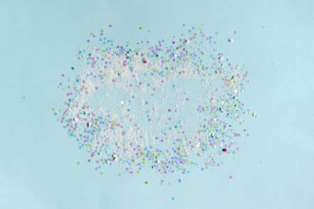 Gently blue background, pastel color, dry sparks scattered in a circle. Dazzling round sequins for embellishment.の写真素材