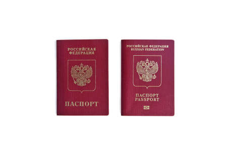 Two Russian passports lie next to each other on a white background