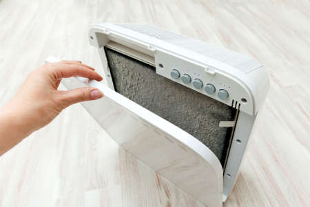 household dust cleaner for allergy sufferers, replacing dirty charcoal filterの写真素材