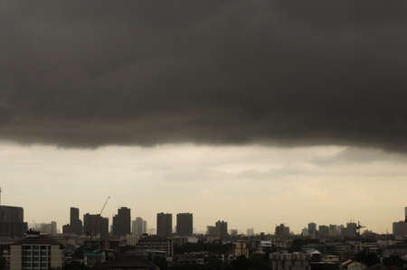 Dark clouds layer cover above Bangkok city before raining in monsoon season.