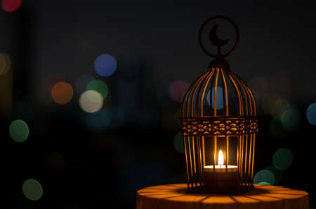 Beautiful Lantern that have moon symbol on top with city bokeh light on dark background for the...