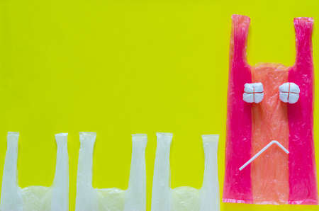 Pink plastic set as unhappy expression face with plastic straw for stop using unfriendly...