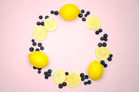 Fresh blueberries and lemon on top view with pastel pink color background for healthy food concept.の写真素材