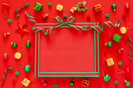 New yearâ€™s ornament decorations with empty space set as gift box and ribbon on red...