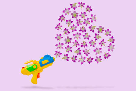 Yellow water gun with pink orchid flowers that set as splash water from them for Water or Songkran...