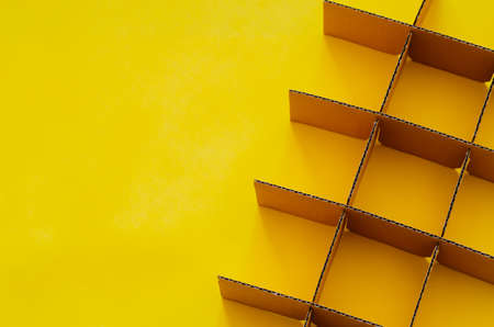 Paper box cutting and set as square shape on yellow background for background and textured concept.の写真素材