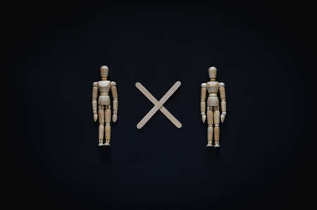 Two wood models keep distance with the gap to protect infection of coronavirus or covid-19. New normal and social distancing concept.の写真素材