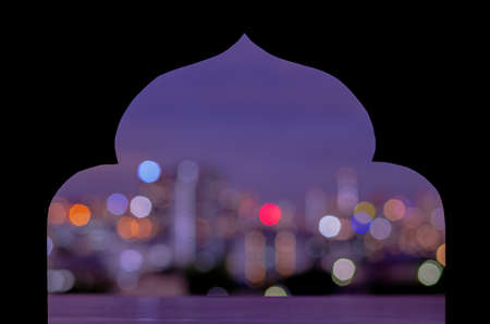 Black paper cut in mosque shape with colorful city bokeh light background. Islamic new year concept.の写真素材