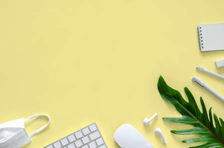 Flat lay of white mask, school and office stationery supplies for new normal office concept.の写真素材