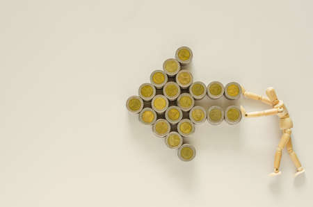 Wood model pushing Thai baht coins that set as growth forward  arrow.