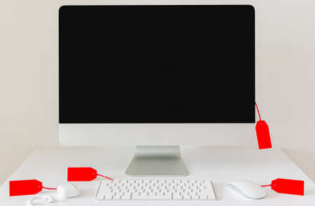 Discount technology merchandises with red price tags on white background. Cyber Monday concept.の写真素材