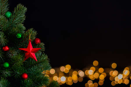 The star ornaments decorate on Christmas tree with bokeh lights background. Christmas and New year...