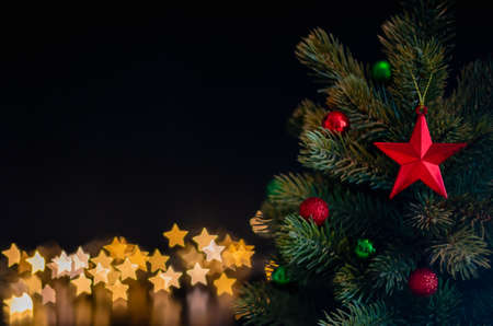 The star ornaments decorate on Christmas tree with star bokeh lights background. Christmas and New year concept.の写真素材