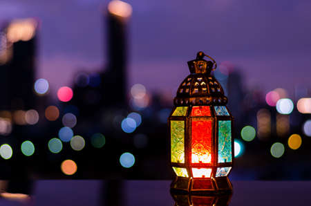 Lantern with night sky and city bokeh light background for the Muslim feast of the holy month of Ramadan Kareem.の写真素材