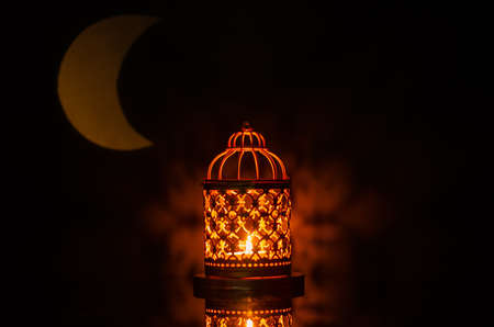 Selective focus of lantern with moon shape from light on background for the Muslim feast of the holy month of Ramadan Kareem.の写真素材