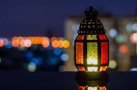 Lantern with apartment building background for the Muslim feast of the holy month of Ramadan Kareem.の写真素材
