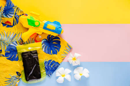 Colorful shirt with water gun and waterproof case for smartphone for Songkran Festival celebration...