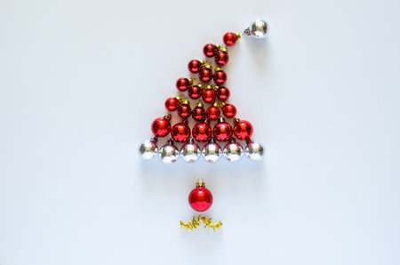 Colorful baubles ornament set as santa claus face and hat on white background. Mimimal Christmas holiday concept.の写真素材
