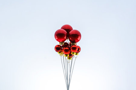 Christmas red baubles ornament set as ballon on top with white background. Minimal holiday concept.の写真素材