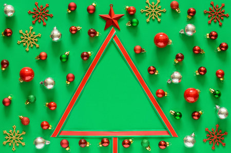 Colorful baubles ornament and ribbon set and Christmas tree on green background with space for text. Christmas holiday concept.の写真素材